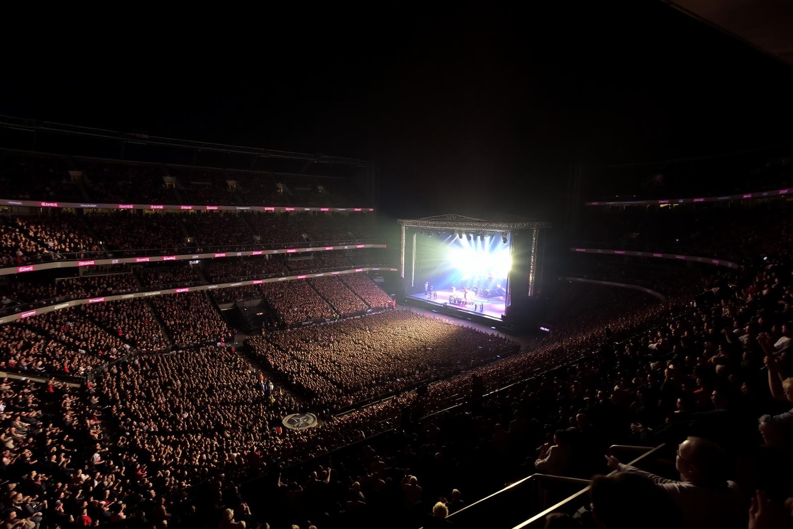 Packed stadium concert viewed from upper level